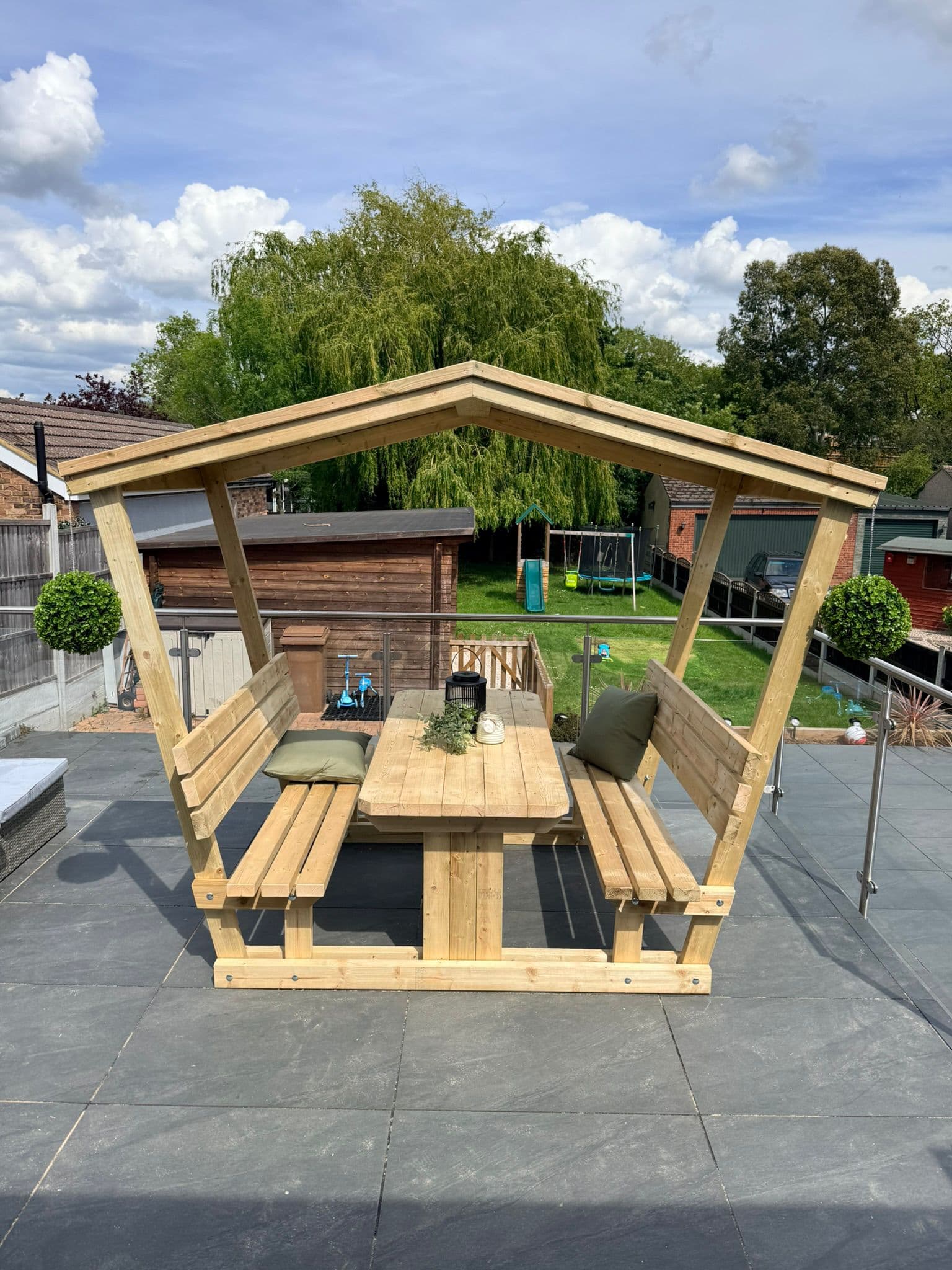 Bespoke pergola with built-in bench seating and table built in Essex