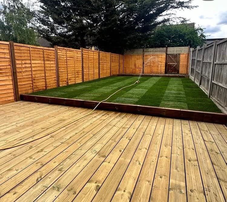 Finished garden landscaping with timber decking and artificial grass in Essex